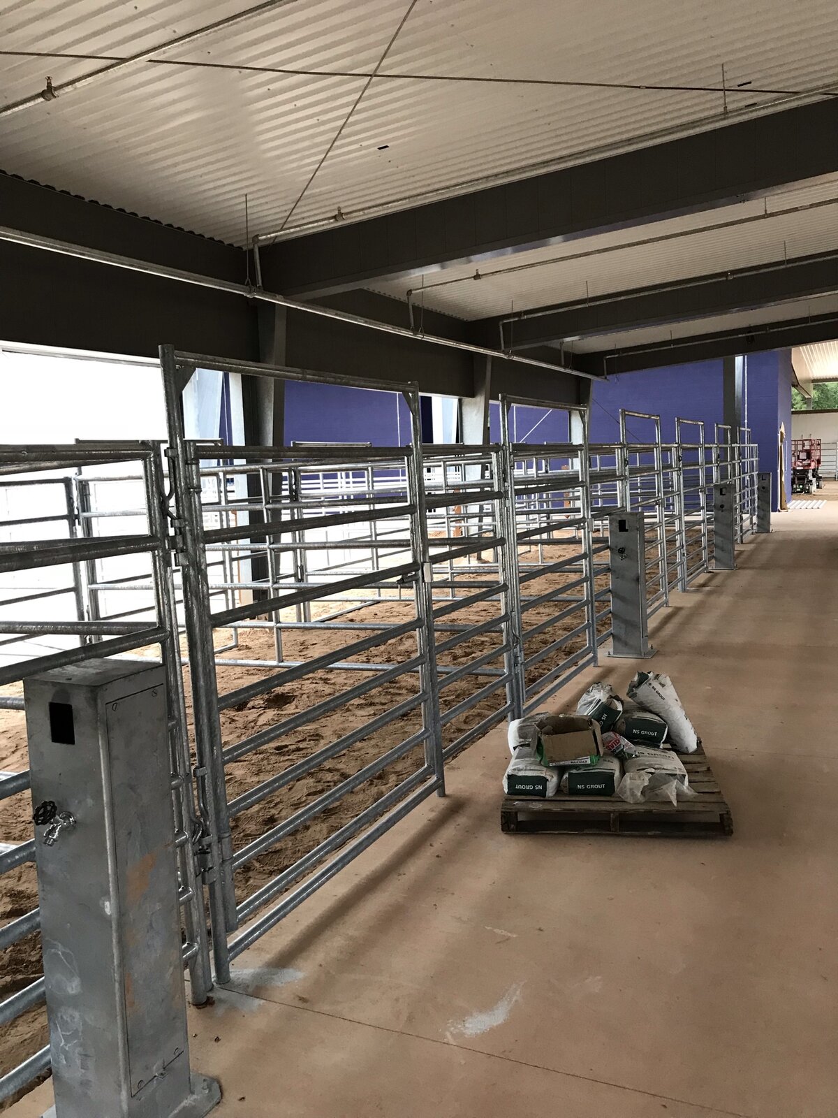 Indoor galvanized show stalls inside the Conroe ISD ag barn