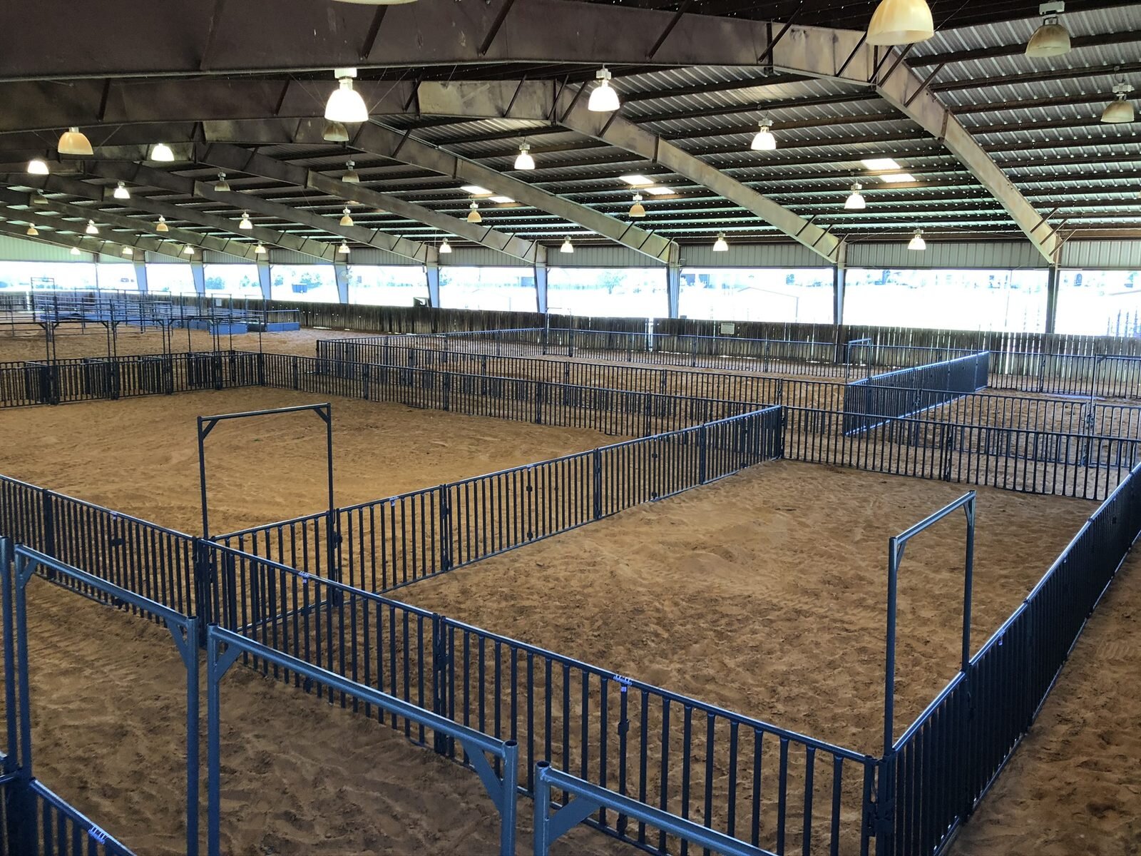 Show pens set up inside a covered livestock arena