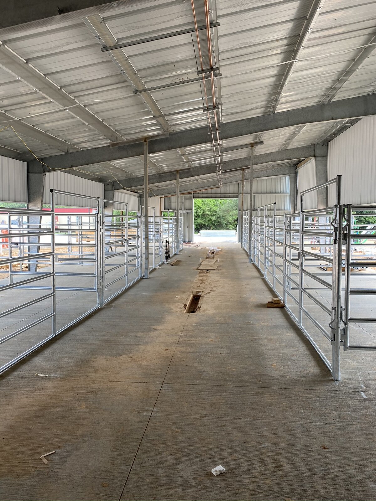 Covered pens and center aisle inside the Tomball ISD ag barn